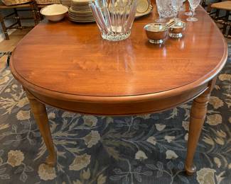 Cherry dining table with hand - turned legs, three leaves included with table and large area floral rug with blue tones