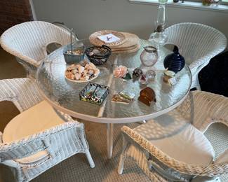 Vintage white wicker patio chairs, and metal and glass patio table, outdoor candles, shells, and more