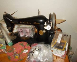 Working electric Singer sewing machine in cabinet