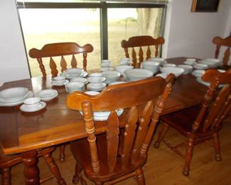 Dining table with 6 chairs shown with 2 leaves