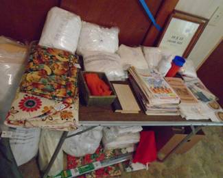 If you look under the table and behind it to the left, you will note that we have a lot of linens and we also have mattress pads and covers for full size.