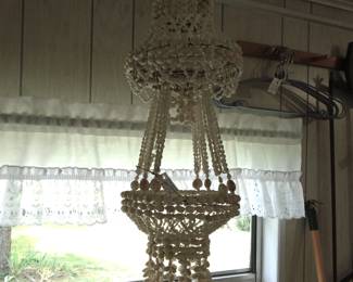 I love this flower pot holder. Made of wire and shells.