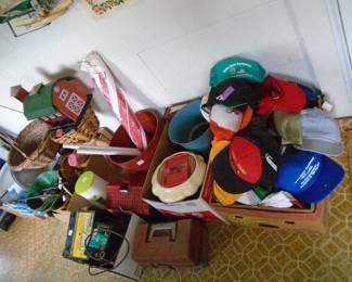 The red and white umbrella in the center has a pole. Lots of collectible ballcaps advertising mainly local Blount County Business.