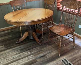 Oak Pedestal Dining Table with Lion Claw Feet and 4 Chairs (one not in photo).