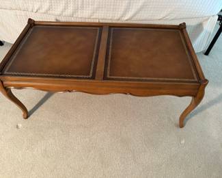 Coffee table with leather inset top