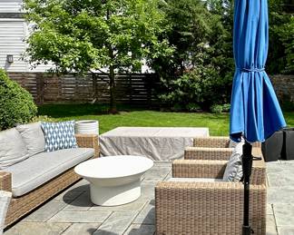 Pottery Barn Wicker Sofa with Sunbrella Cushions in Excellent Condition.  The Set includes 2 Matching Chairs and Cushions as well as Custom Pottery Barn Covers.  Pictured Blue Umbrella and Base from West Elm.