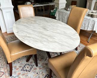 marble top oval table with 4 leather chairs
