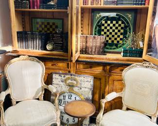 Bookcase with Antique Booksets. French Chairs