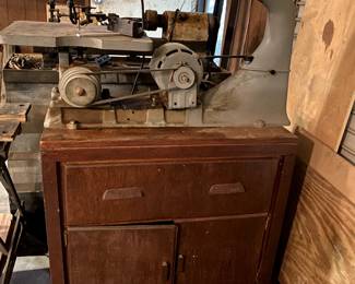 Scroll saw mounted to a rolling storage cabinet.