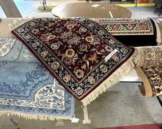 Lots of hand tied area rugs. 