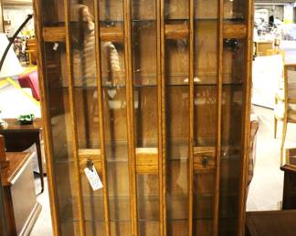 Mid Century Modern display cabinet with six shelves.                   Vertical wood design on front glass doors.                                                 80"H x 34"W x 13 1/2"D