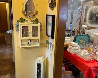 There are several different items shown here, including the coat hooks, wall-mounted cabinet, mirror, and clock.