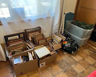 Lots and lots of picture frames and a small keyboard are shown in this photo.