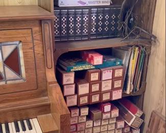 The bookcase to the right of the piano holds the piano rolls and other items.