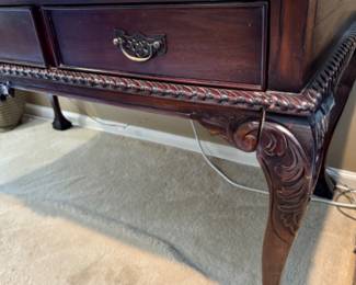 Inset leather top carved mahogany desk
