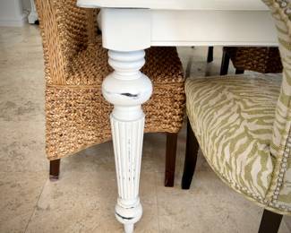 White painted dining table with - can sit 8-10 people with leaf in it. Six sisal/rattan chairs and two upholstered green chairs.