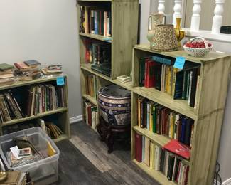 wood bookcases with brass corner detail, porcelain figurines, books