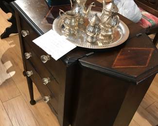 antique sewing cabinet with glass knobs, silver tea set