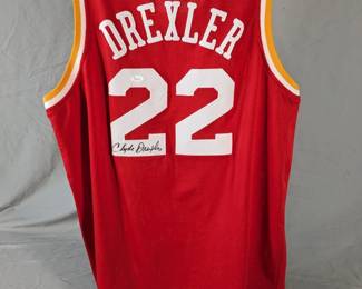 Lot 100: Autographed Houston Rockets Clyde Drexler jersey in size XL, JSA certified and has certification card