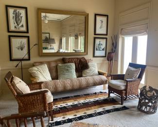 Leopard covered futon , pair of wicker arm chairs, great mirror , carved African table  with animal motif, Navajo rug