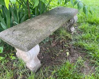 Concrete bench , there are many statues & yard pieces 