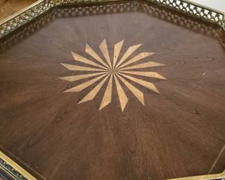 Occasional table with inlay design on top, metal rail and iron legs