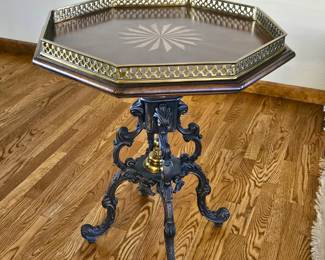 Occasional table with inlay design on top, metal rail and iron legs