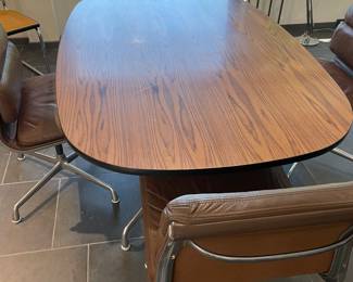 $2,800 Eames vintage table and four chairs. Table is aluminum based with Rosewood veneer top. Chairs are all original leather with fabric back. Table is 65.5”L X 41.5”W X 28.5”H. Chairs measure 21”w X 21.5”d X 33”h.