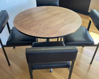 $540 Eames aluminum based table with Rosewood veneer top. (As found, slight sun fade) 35.5” dia. X 28”h. (Chairs sold separately)