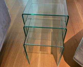 $220 Set of three glass nesting tables. Largest table measures 16.5w X 16.5d X 16.5h