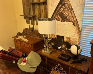 Lamp, artwork, hope chest , small wooden chest with drawers. Wood floating shelves. 