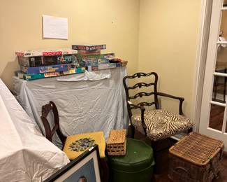 Games, puzzles, art, animal print antique chair. Small green footrest, basket for blankets. 