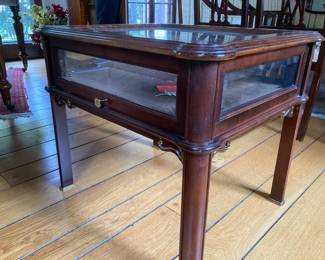 $200; Franklin Mint glass display side/coffee table with pull out drawer, brass accents. Has keys. 22” deep; 26” long; 22.5” high. Pull out drawer: 21” wide; 18” deep; 5” to glass. 