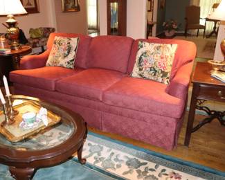 Comfortable rose/red woven fabric on like new sofa; attached back cushions, loose bottom cushions. Ethan Allen mahogany tables, den