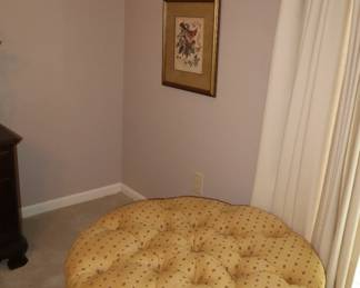 36" dia fully upholstered ottoman in primary bedroom
