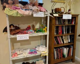 Vintage dolls and doll clothes; old pine bookcase