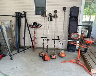 Lots of yard tools, mowers, weed eaters, chain saws, tools and golf carts