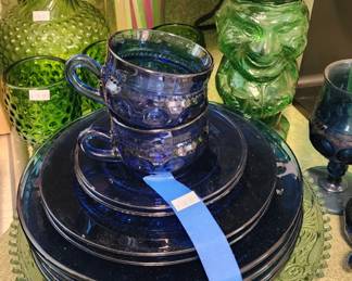 Blue glass plates, Green hobnail pitcher
