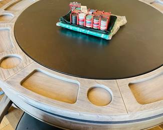 Top is reversible on this handsome game table with leather chairs