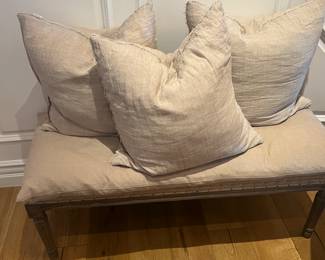 Antique bench with throw pillows