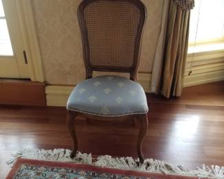 Cane back chair with upholstered seat