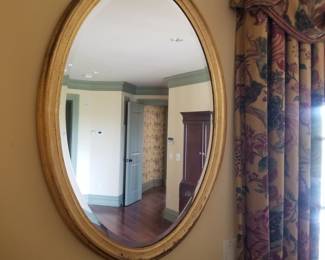 Gilded oval wall mirror