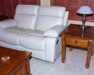 White leather reclining loveseat, end table with lamp