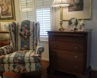 Lovely floral wingback, cherry 4 drawer chest and brass lamp.