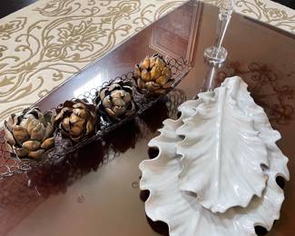 Artichokes in metal basket, ceramic leaf plates, and crystal pillar holder