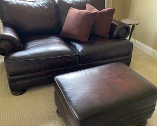 Leather loveseat and matching ottoman by Bernhardt