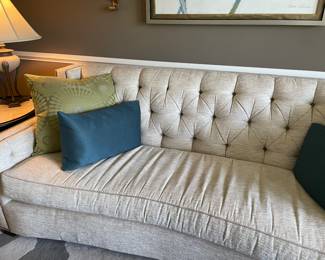 Another view of the curved couch with tufted back