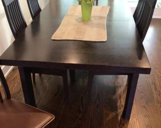 Large modern diningroom table with leaf. Leather chairs sold separately $60 each. Table $400. Set $500