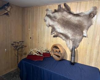 Reindeer pelt from Alaska, antler shelves, 1942 shell from tanks and ships 