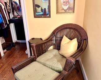 Two plantation style rattan chairs and ottomans.